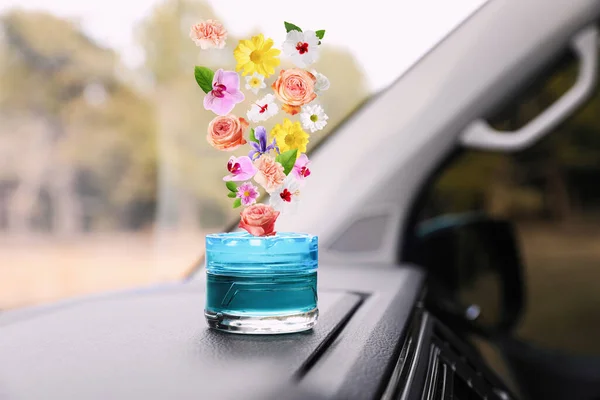 Air freshener on dashboard in car. Flowered aroma