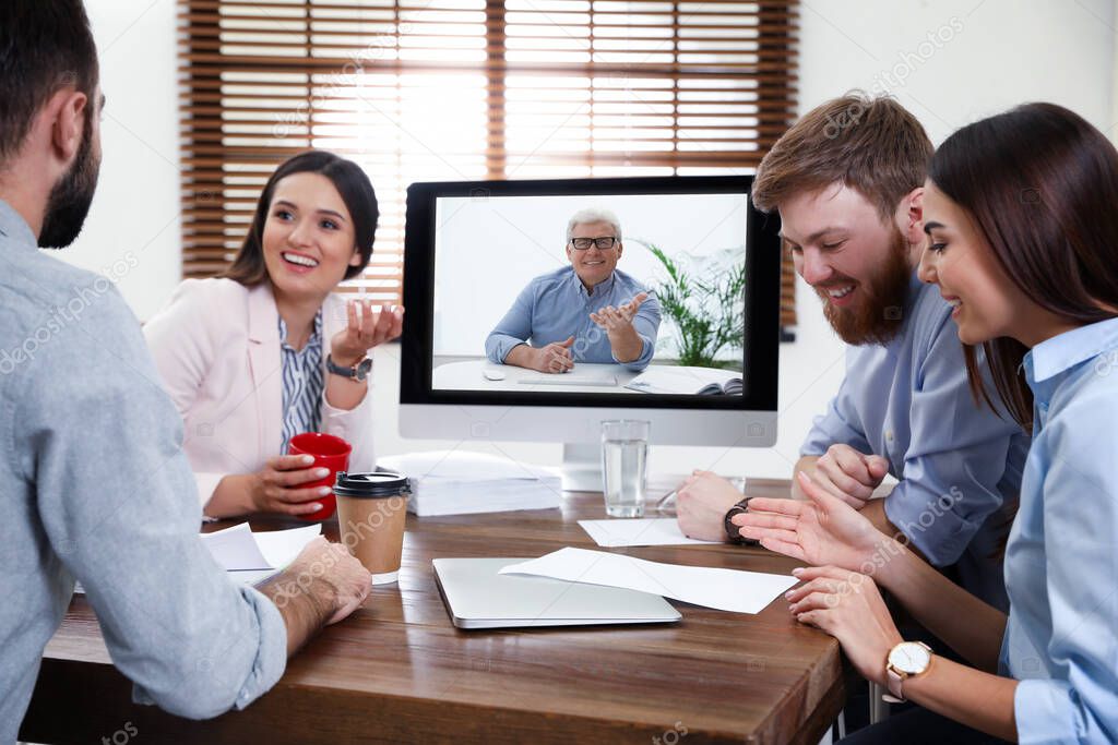 Group of colleagues using video chat for online job interview in office 
