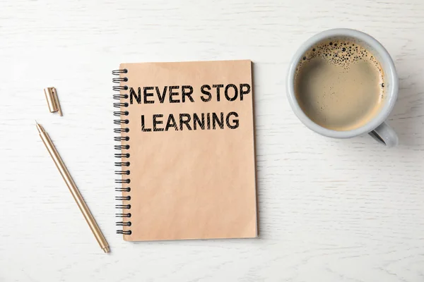 Notebook Phrase Never Stop Learning Pen Cup Coffee White Wooden — Stock Photo, Image