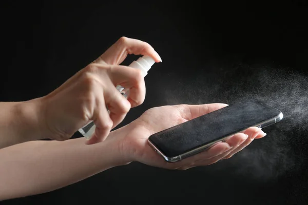 Woman Spraying Antiseptic Smartphone Black Background Closeup — Stock Photo, Image