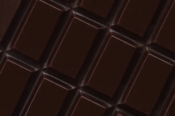 Delicious Dark Chocolate Background Closeup View — Stok Foto