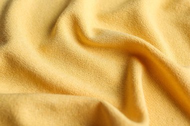 Arka plan olarak güzel sarı kumaşın dokusu, yakın plan