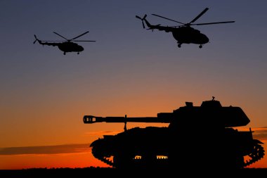 Gün batımında ordu tankı ve helikopterlerin siluetleri. Askeri makineler. 