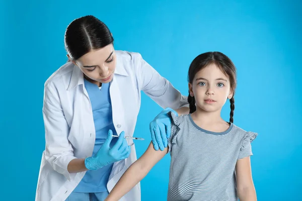 Médecin Vaccinant Petit Enfant Sur Fond Bleu Clair — Photo