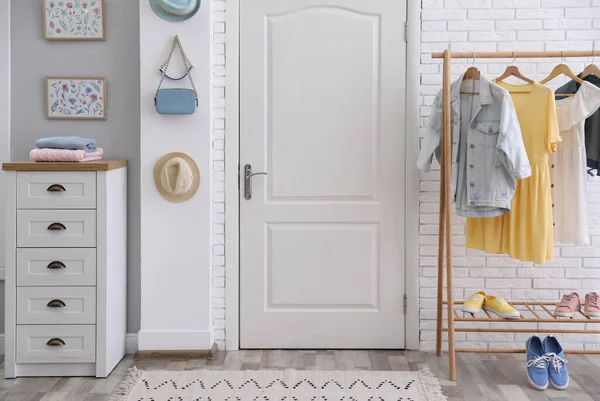 Hallway interior with stylish furniture, clothes and accessories