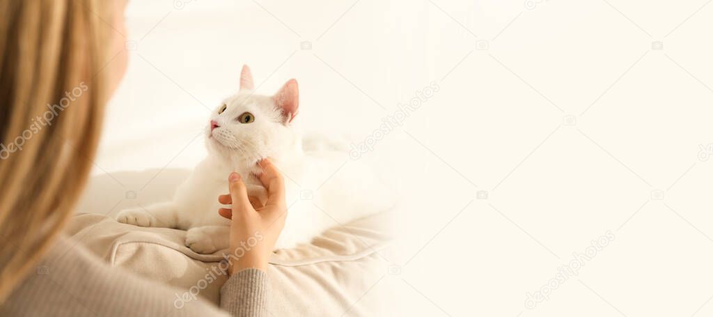 Young woman with her beautiful pet at home, space for text. Banner design