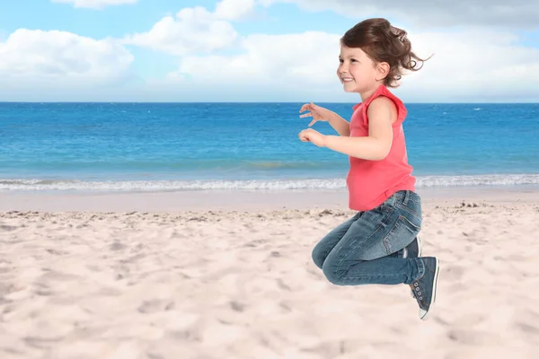 Happy school girl jumping on beach near sea, space for text. Summer holidays