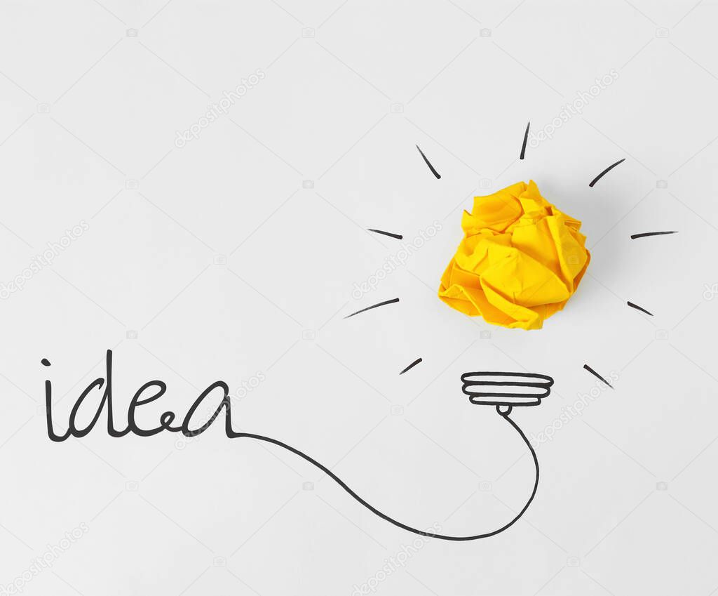 Idea concept. Composition with crumpled paper ball and drawing of lamp bulb on white background, top view