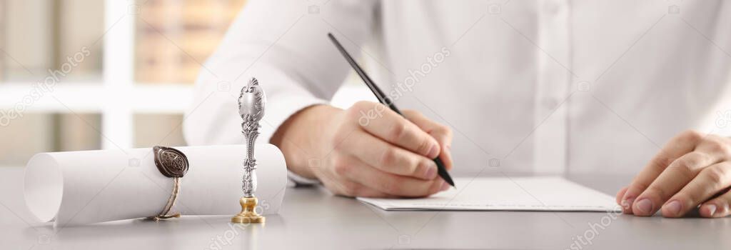 Male notary working with documents at table in office, closeup. Banner design