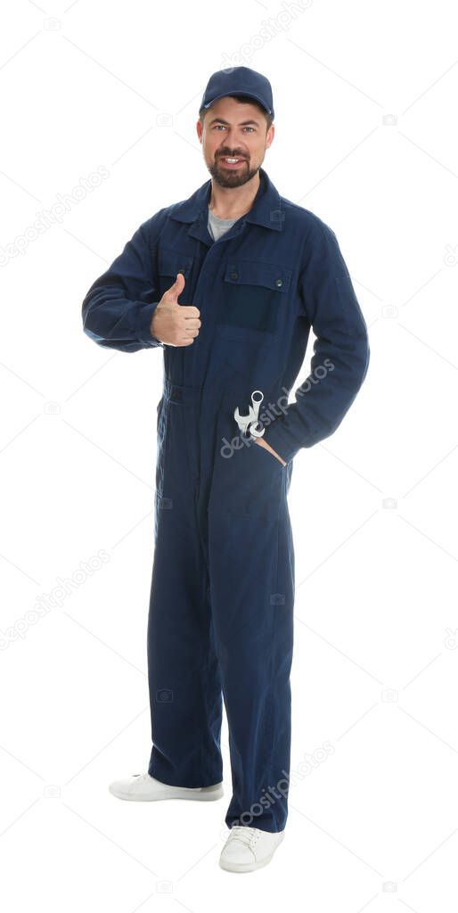 Full length portrait of professional auto mechanic with wrenches on white background