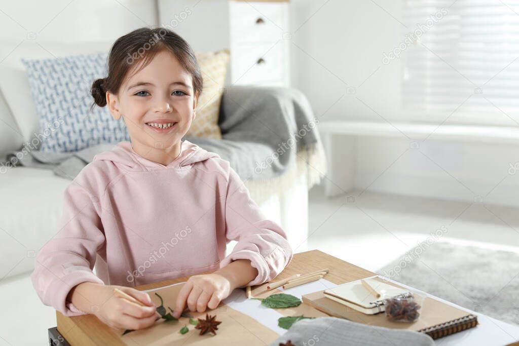 Little girl working with natural materials at table indoors, space for text. Creative hobby