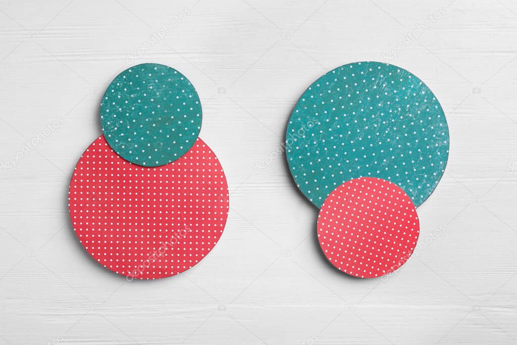 Red and green circles on white wooden background, flat lay. Pareto principle concept