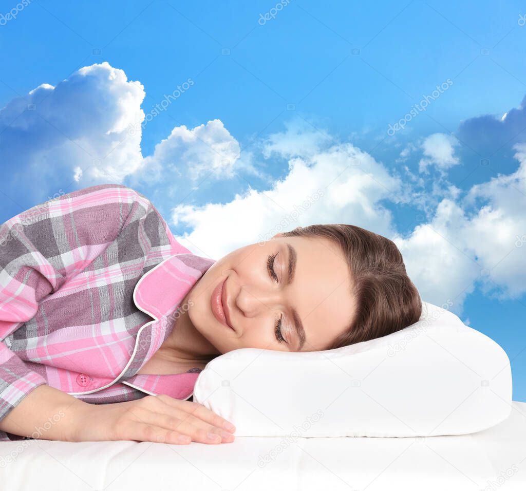 Young woman sleeping on mattress. Blue sky on background