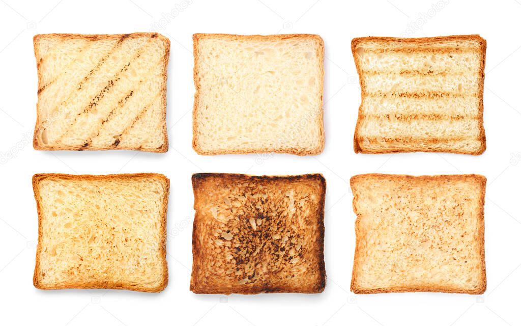 Set of toasted bread slices on white background, top view