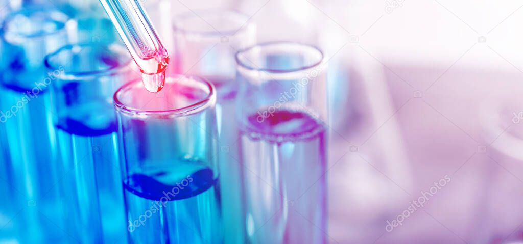 Dripping liquid from pipette into test tube on light background, banner design. Laboratory analysis