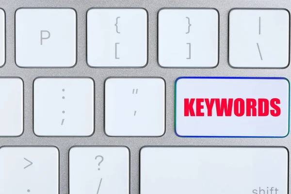 Tastatur Mit Text Keyworten Als Hintergrund Draufsicht — Stockfoto