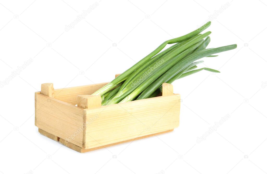 Fresh green spring onions in wooden crate isolated on white