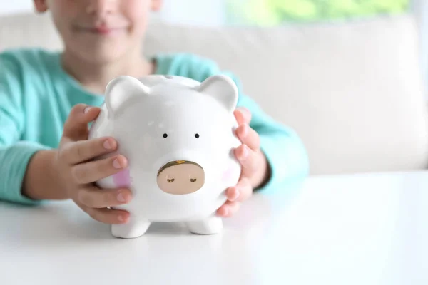 Little Boy Piggy Bank White Table Indoors Closeup Space Text — Stock Photo, Image
