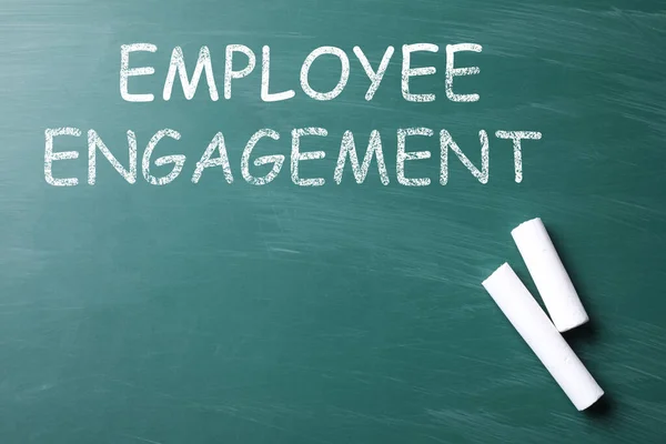 Text Employee Engagement and chalk on greenboard, top view