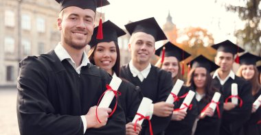 Kampüs yakınlarında diploması olan mutlu öğrenciler. Pankart tasarımı