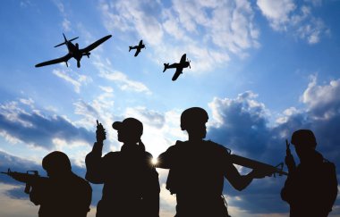 Silhouettes of soldiers in uniform with assault rifles and military airplanes patrolling outdoors clipart