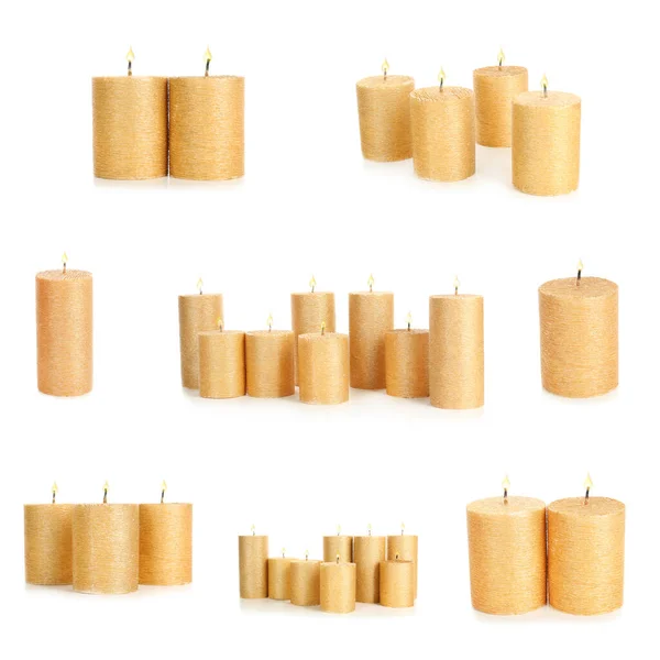 Set Brandende Gouden Kaarsen Witte Achtergrond — Stockfoto