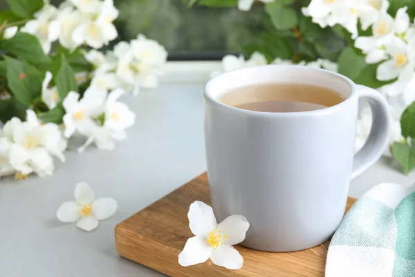 Cup Tea Fresh Jasmine Flowers Light Grey Table Space Text — Stock Photo, Image