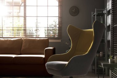 Rahat koltuğu ve deri koltuğu olan şık bir oturma odası.