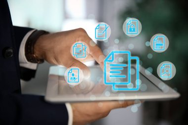 Kapalı alanda tablet ve belge simgeleri kullanan adam, kapat