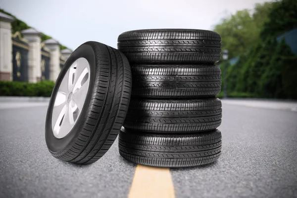 Black car tires on asphalt road outdoors