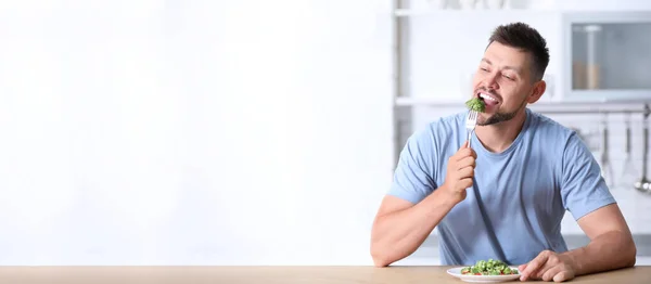 Portrait Happy Man Eating Broccoli Salad Kitchen Space Text — Stock Photo, Image
