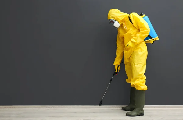 Trabajador Control Plagas Traje Protector Rociando Pesticidas Cerca Pared Negra —  Fotos de Stock