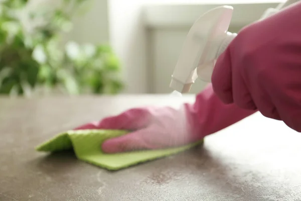 Frau Handschuhen Reinigt Braunen Marmortisch Mit Sprühwaschmittel Und Lappen Drinnen — Stockfoto