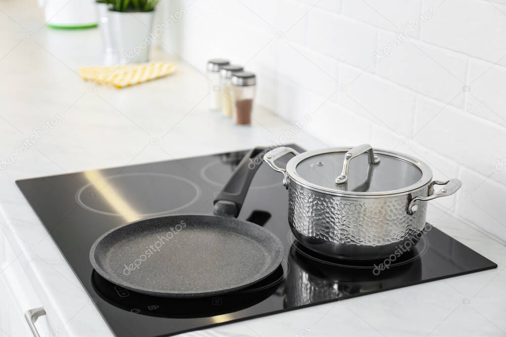Pot and frying pan on stove in kitchen