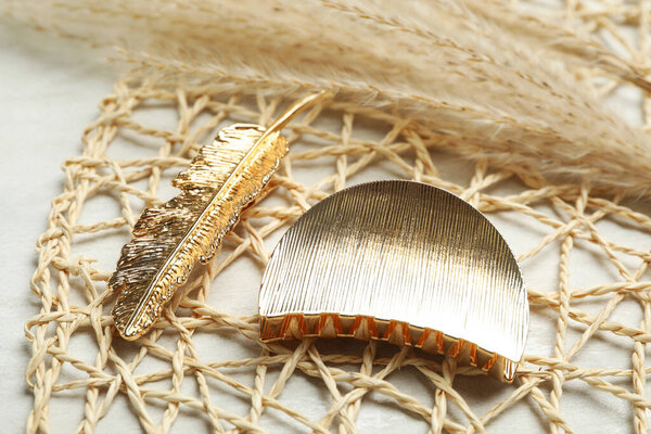 Beautiful gold hair clips on white table