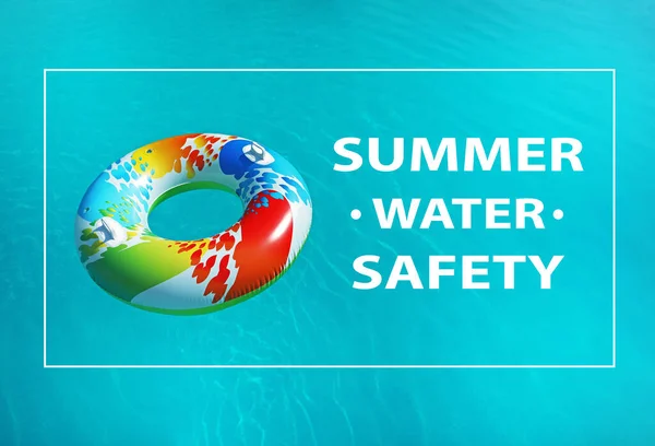 Summer water safety. Colorful inflatable ring floating in swimming pool