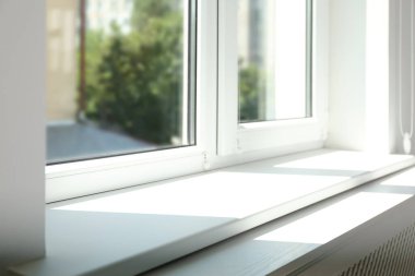 Closeup view of window with empty white sill clipart