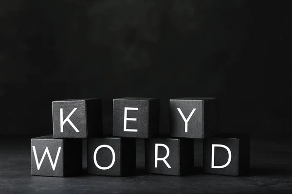 Word Keyword Készült Fekete Kockák Sötét Háttér — Stock Fotó
