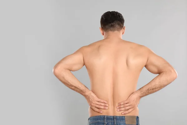 Man Suffering Lower Back Pain Light Grey Background Visiting Orthopedist — Stock Photo, Image