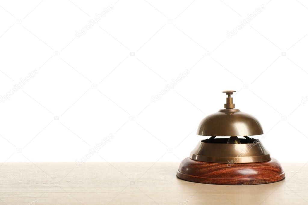 Hotel service bell on wooden table against white background