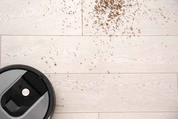 Modern Robotic Vacuum Cleaner Removing Scattered Buckwheat Wooden Floor Top — Stock Photo, Image