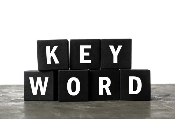 Черные Кубики Словом Keyword Сером Столе — стоковое фото