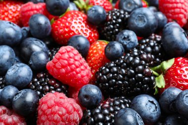 Mix of different ripe tasty berries as background, closeup view clipart