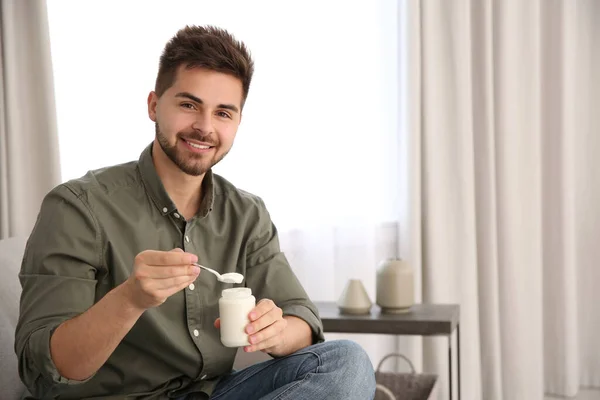 Jovem Feliz Com Iogurte Saboroso Sala Estar Espaço Para Texto — Fotografia de Stock