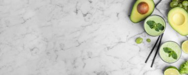 Lezzetli avokado smoothie ile mermer masa üzerinde düz kompozisyon, metin için boşluk. Pankart tasarımı