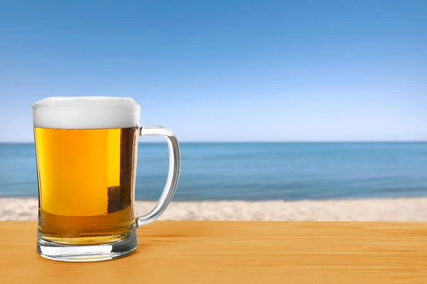 Cold Beer Wooden Desk Blurred Sea Space Text Stock Image