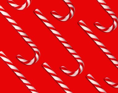 Kırmızı arka planda Noel şeker kamışları deseni, üst manzara