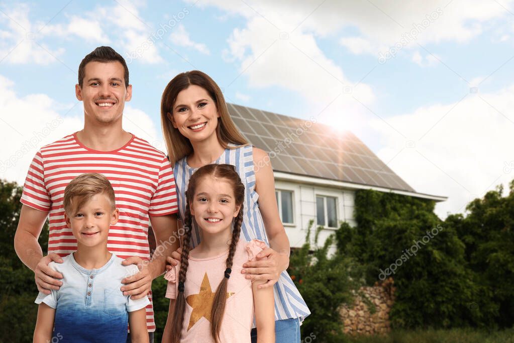Happy family near their house with solar panels. Alternative energy source
