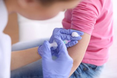 Küçük kız klinikte suçiçeği aşısı oluyor, yakın plan. Varicella virüs önleme