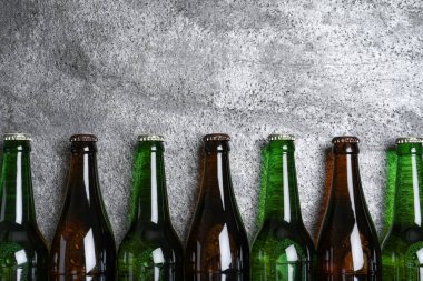 Bira şişeleri gri masada, düz yerde. Metin için boşluk
